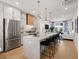 Open concept kitchen with stainless steel appliances, a center island with seating, and a view of the living area at 201 New St # 2207-1, Decatur, GA 30030