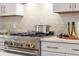 Close up of a modern gas stovetop and white kitchen countertops at 201 New St # 2207-1, Decatur, GA 30030