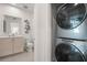 Convenient laundry area with stackable washer and dryer near a bathroom at 201 New St # 2207-113, Decatur, GA 30030