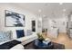 Open-concept living room with hardwood floors and kitchen view, perfect for entertaining at 201 New St # 2207-1, Decatur, GA 30030