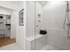 Elegant shower with tiled walls, built in soap dishes, and a bench for a spa-like experience at 201 New St # 2207-1, Decatur, GA 30030