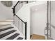 Modern staircase with dark wood treads, white risers, and a black wrought iron railing at 201 New St # 2207-1, Decatur, GA 30030