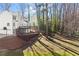 Large backyard with a two-story home, back deck, and wooded area at 3189 Saddleback Mountain Rd, Marietta, GA 30062