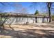 The backyard has mature trees offering shade and a concrete pad at 3759 Rosemary Se Ln, Conyers, GA 30013