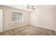 Cozy bedroom with neutral carpeting, a window letting in natural light, and a ceiling fan at 3759 Rosemary Se Ln, Conyers, GA 30013