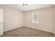 A cozy bedroom with neutral carpeting and a window that lets in plenty of natural light at 3759 Rosemary Se Ln, Conyers, GA 30013
