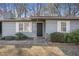 Charming home exterior features a black front door, complemented by white window shutters at 3759 Rosemary Se Ln, Conyers, GA 30013