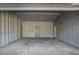 An empty garage with concrete floor and a wooden door at 3759 Rosemary Se Ln, Conyers, GA 30013