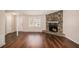 Inviting living room with hardwood floors, a stone fireplace, and a white door at 3759 Rosemary Se Ln, Conyers, GA 30013