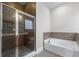 Elegant bathroom featuring a glass-enclosed shower and a separate soaking tub, enhancing relaxation at 407 Highgate Place, Lawrenceville, GA 30046