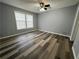 Comfortable bedroom featuring hardwood floors, neutral walls, and plenty of natural light at 5559 John Burruss Rd, Cumming, GA 30040