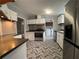 Updated kitchen features stainless steel appliances and herringbone flooring at 5559 John Burruss Rd, Cumming, GA 30040