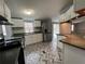 Updated kitchen features stainless steel appliances, herringbone flooring, and great lighting at 5559 John Burruss Rd, Cumming, GA 30040