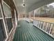 A cozy, covered porch features a stone wall and painted wooden flooring at 5559 John Burruss Rd, Cumming, GA 30040