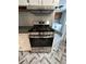 Modern stainless steel gas range with overhead vent at 5559 John Burruss Rd, Cumming, GA 30040