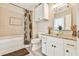 Bathroom with a white tub, granite countertop, and glass vessel sink at 1830 Greystone Ct, Marietta, GA 30068