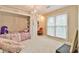 Bedroom with custom built ins, large window, and chandelier at 1830 Greystone Ct, Marietta, GA 30068