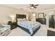 Spacious bedroom with tray ceilings, ceiling fan, and access to bathroom at 1830 Greystone Ct, Marietta, GA 30068