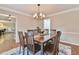 A dining room featuring a wooden table set on an area rug beneath a chandelier at 1830 Greystone Ct, Marietta, GA 30068