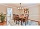 Elegant dining room with hardwood table and chairs, area rug, and chandelier at 1830 Greystone Ct, Marietta, GA 30068