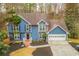 Beautiful exterior view of a two-story blue home with an attached two-car garage at 1830 Greystone Ct, Marietta, GA 30068