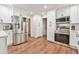 Bright, modern kitchen featuring stainless steel appliances and white cabinets at 1830 Greystone Ct, Marietta, GA 30068