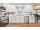 Bright kitchen featuring white cabinetry, stainless steel appliances, and hardwood floors at 1830 Greystone Ct, Marietta, GA 30068