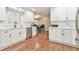 Bright white kitchen featuring modern cabinets, stainless steel appliances, and hardwood floors at 1830 Greystone Ct, Marietta, GA 30068