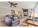 A living room with a ceiling fan, stone fireplace and stylish furnishings at 1830 Greystone Ct, Marietta, GA 30068