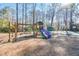 Community playground featuring slides, swings, and a basketball court, set in a mulched play area at 1830 Greystone Ct, Marietta, GA 30068