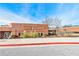 Dickerson Middle School exterior with a brick facade, well-kept landscaping, and a clear blue sky at 1830 Greystone Ct, Marietta, GA 30068