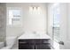 Bathroom featuring a single sink vanity, toilet, and window with natural light at 2028 Holtz Ln, Atlanta, GA 30318