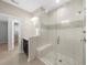 A modern bathroom with a glass shower, modern fixtures, and stylish tiling at 2028 Holtz Ln, Atlanta, GA 30318