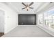 A spacious bedroom with tray ceiling, ceiling fan and a modern black accent wall design at 2028 Holtz Ln, Atlanta, GA 30318