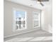 Bright bedroom with carpeting, a ceiling fan, and large windows that let in lots of natural light at 2028 Holtz Ln, Atlanta, GA 30318