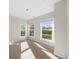 Sunlit bedroom with neutral carpeting, three windows, and serene ambiance at 2028 Holtz Ln, Atlanta, GA 30318