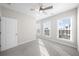 Bedroom with three bright windows, neutral walls, and a ceiling fan at 2028 Holtz Ln, Atlanta, GA 30318