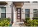 Inviting entryway with a brick facade, decorative front door, and manicured landscaping at 2028 Holtz Ln, Atlanta, GA 30318