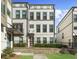 A charming three-story townhome featuring a well-kept lawn and a classic exterior design at 2028 Holtz Ln, Atlanta, GA 30318