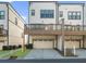 Modern home exterior featuring a private deck above the garage at 2028 Holtz Ln, Atlanta, GA 30318