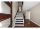 Elegant foyer with hardwood floors and a staircase featuring black and white accents at 2028 Holtz Ln, Atlanta, GA 30318