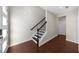 Bright foyer featuring hardwood floors, staircase with a black railing, and white walls at 2028 Holtz Ln, Atlanta, GA 30318