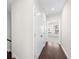 Hallway showcasing hardwood floors, multiple white closet doors, and entry into a naturally lit room at 2028 Holtz Ln, Atlanta, GA 30318