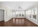 Bright living room featuring hardwood floors, a ceiling fan, and large windows for ample natural light at 2028 Holtz Ln, Atlanta, GA 30318