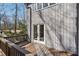 Exterior view of a home from the wood deck showing siding and a treed backyard at 566 Hickory Hills Ct, Stone Mountain, GA 30083