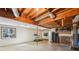 Unfinished basement area featuring exposed beams, a window, and ample open space at 566 Hickory Hills Ct, Stone Mountain, GA 30083