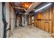 Unfinished basement with exposed ductwork, an HVAC system, and open framing at 566 Hickory Hills Ct, Stone Mountain, GA 30083