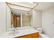 Bathroom vanity featuring a large mirror with a skylight, plus a shower/tub combo at 566 Hickory Hills Ct, Stone Mountain, GA 30083