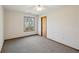 Cozy bedroom with neutral carpet, ceiling fan, natural light, and a closet door at 566 Hickory Hills Ct, Stone Mountain, GA 30083