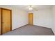 Bedroom with carpet, two doors and ceiling fan at 566 Hickory Hills Ct, Stone Mountain, GA 30083